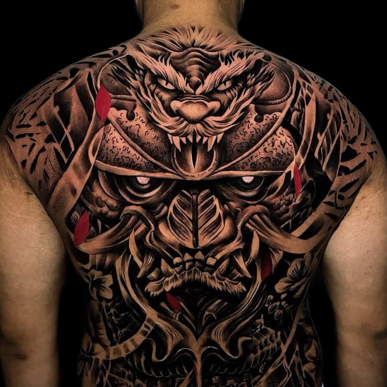 Full-back black-and-grey tattoo with tiger, mask, and red accents — custom work by Aussie Rules Tattoo Studio Bali